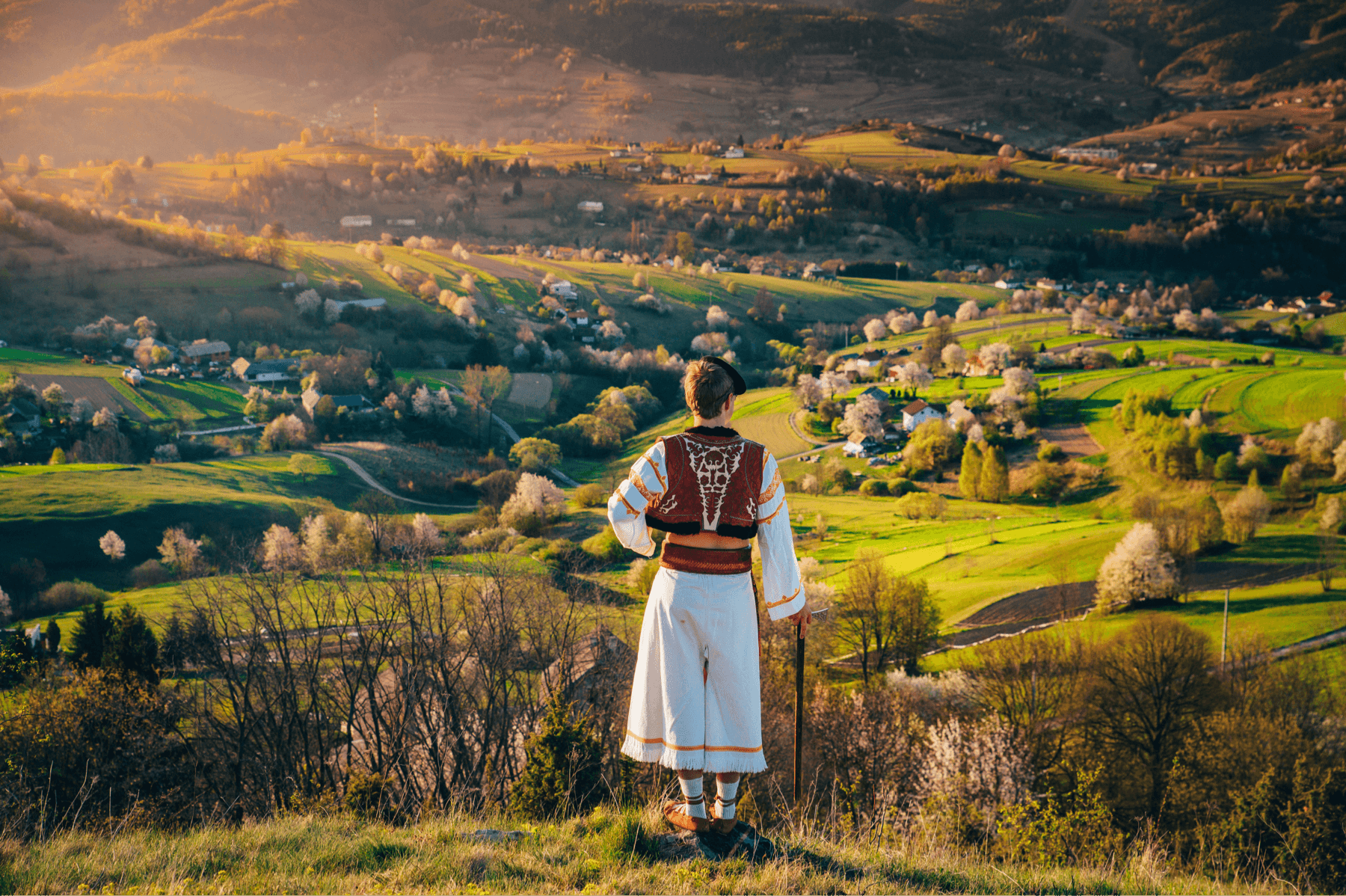 Slovak man in traditional dress overlooking hills