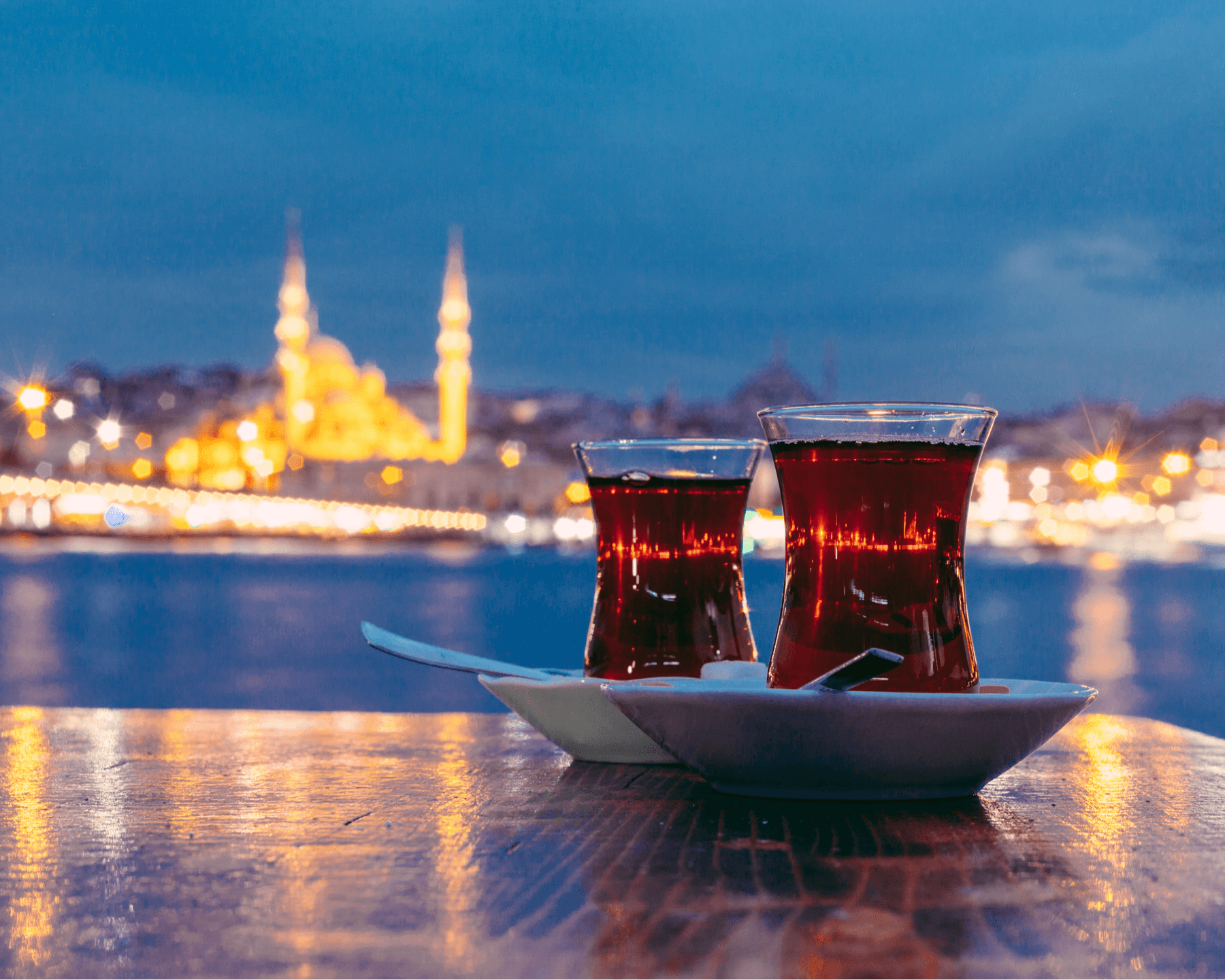 drinks on table with city blurred in background